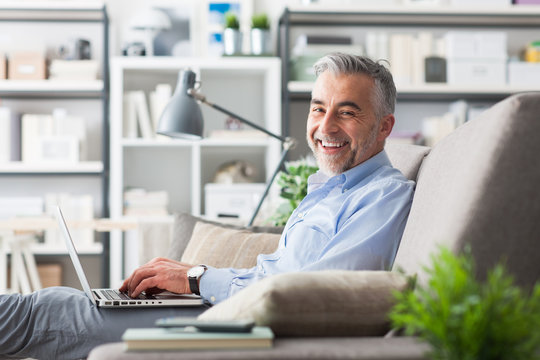 Cheerful businessman working at home