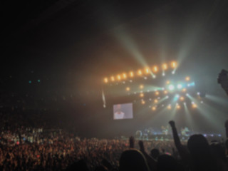 Blurred background : Bokeh lighting in indoor concert with cheering audience