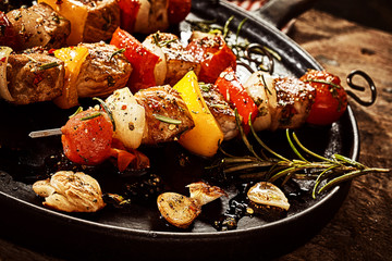 Close up on kebabs in frying pan