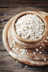 Raw oatmeal cereal on the wooden table