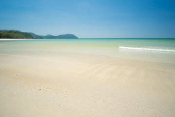 Fototapeta na wymiar Sea and sand on the beach in blue sky.