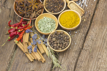 Variety of spices on wooden background