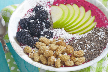 Acai bowl with blackberry, mulberry, coconut, apple and chia seeds