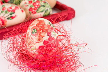 Decoupage Easter egg on red straw