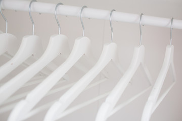 wooden coat hangers on clothes rail