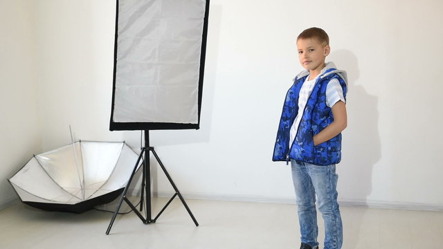 Photographer taking pictures of the child in the studio.