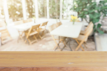 Wooden board empty table in front of blurred background. Perspective brown wood over blur in coffee shop - can be used for display or montage your products.Mock up for display of product.