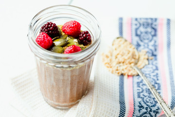 Oatmeal chocolate mousse with berries and pumpkin seeds