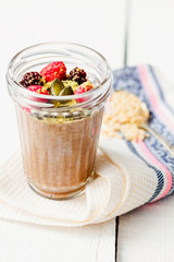Oatmeal chocolate mousse with berries and pumpkin seeds