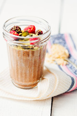 Oatmeal chocolate mousse with berries and pumpkin seeds