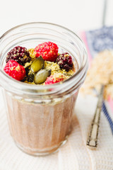 Oatmeal chocolate mousse with berries and pumpkin seeds,selectiv