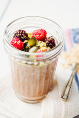 Oatmeal chocolate mousse with berries and pumpkin seeds