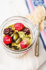 Oatmeal chocolate mousse with berries and pumpkin seeds