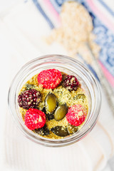 Oatmeal chocolate mousse with berries and pumpkin seeds
