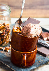 chocolate ice cream with walnuts in a coffee cup, selective focu