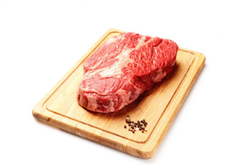 marble veal steak on a board on a white background