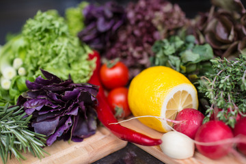 vegetables and lettuce on the wooden cutting board