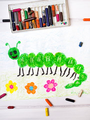 colorful drawing: green caterpillar with happy face