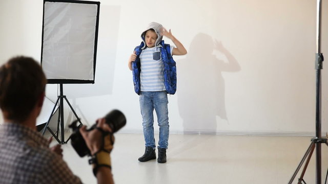 Photographer taking pictures of the child in the studio.