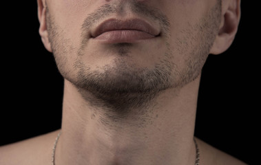  unshaven chin of a young man