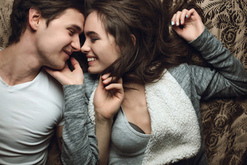 Young beautiful pair of lovers hug and kiss