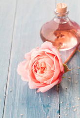Delicate Pink Rose with Bottle of Aromatic Oil