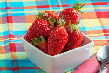Fraises Gariguettes dans une coupe sur nappe en madras