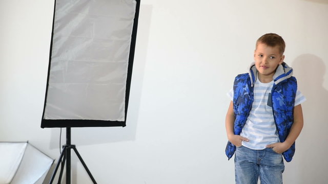 Photographer taking pictures of the child in the studio.