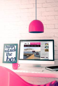 pink workspace with computer showing trends blog