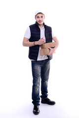 handsome young delivery man isolated on a white background holding a parcel