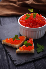 Red caviar on slate background