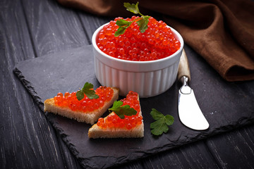 Red caviar on slate background