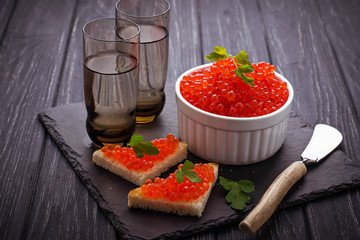 Red caviar on slate background