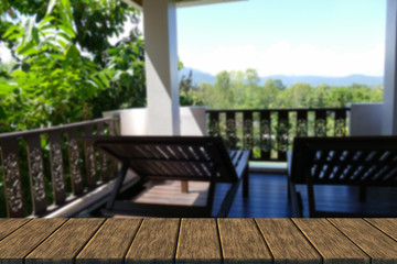 Obraz premium wooden deckchair at the balcony with forest and sky view