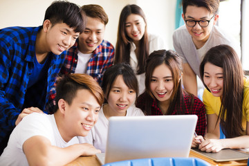 Group of college students watching laptop in classroom © Tom Wang