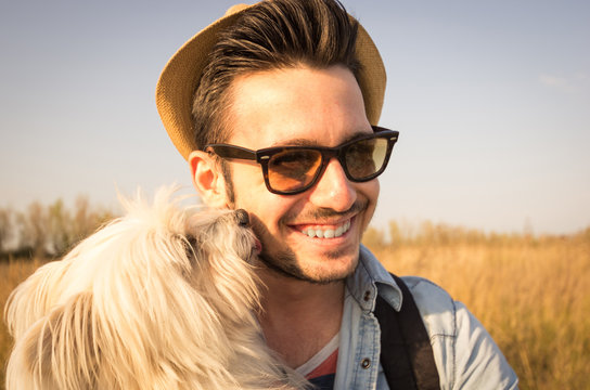 White dog is kissing its owner outdoor 