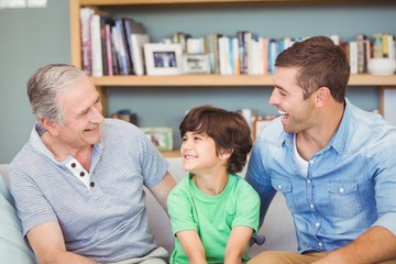Happy multi genration family sitting on sofa 