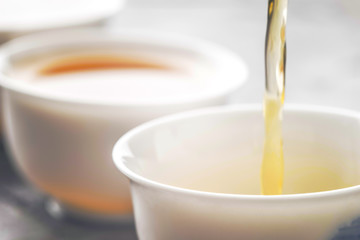Pouring tea into a bowl horizontal