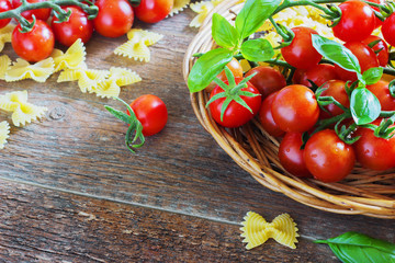 fresh organic cherry tomatoes and paste with basil garlic on a dark background