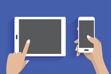 Modern tablet and hand using a smartphone. Blue background.