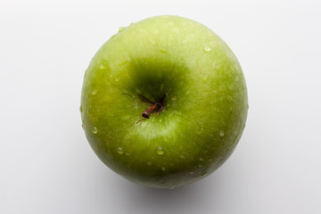 Green fresh ripe apple on white background directly from above