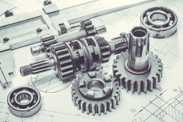 Obraz na płótnie Canvas metal gears on engineering drawings