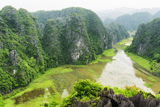 Top view of karst towers, rice fields and the Ngo Dong River