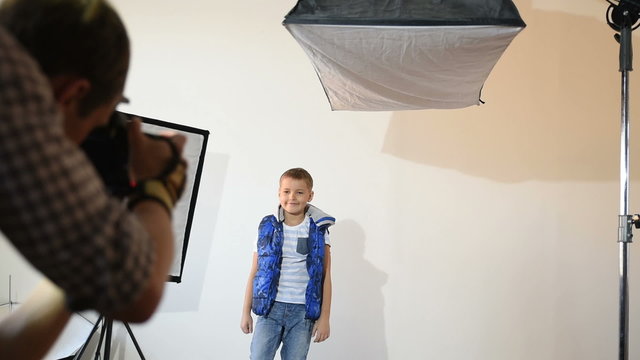 Photographer taking pictures of the child in the studio.