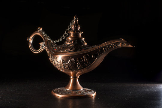 Aladdin's lamp isolated on black background 