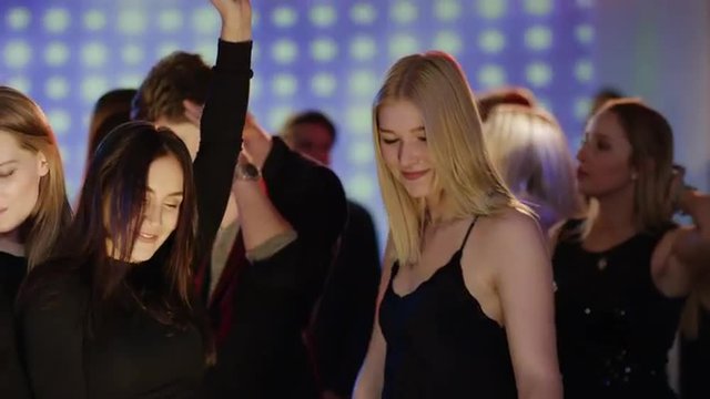 young attractive people dancing at club