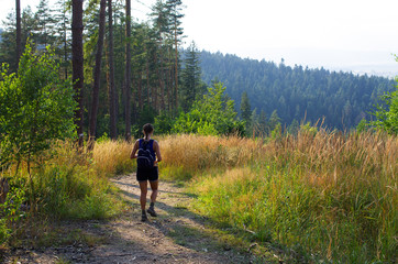 Fototapeta premium Young woman hiking in the hills