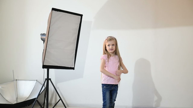 Photographer taking pictures of the child in the studio.