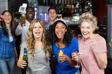 Happy friends watching sport