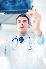 male doctor or dentist looking at x-ray